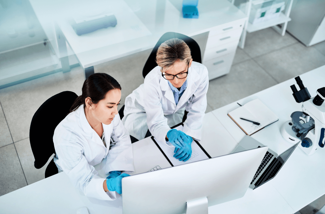 Two doctors looking at results on computer